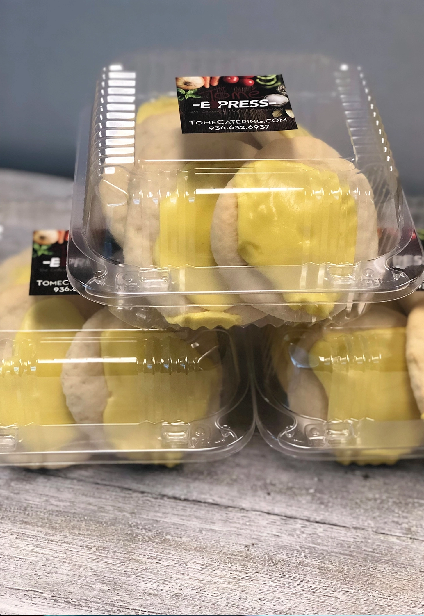 Assorted to-go desserts in clear containers ready for drive-thru or carry-out pickup from Tomé Express.