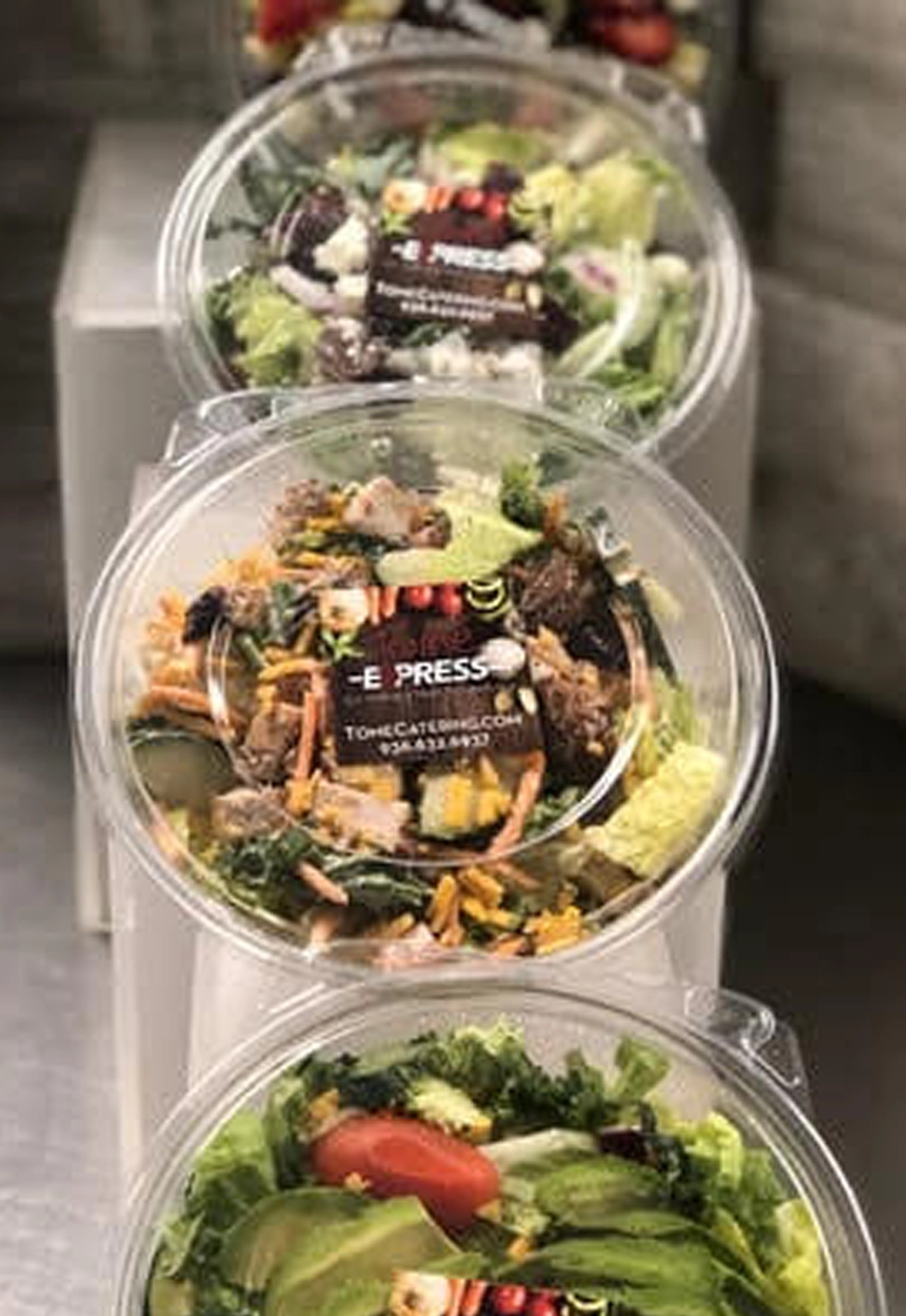 Chef-crafted salads and fit-food bowls packaged for quick drive-thru and carry-out pickup at Tomé Express.